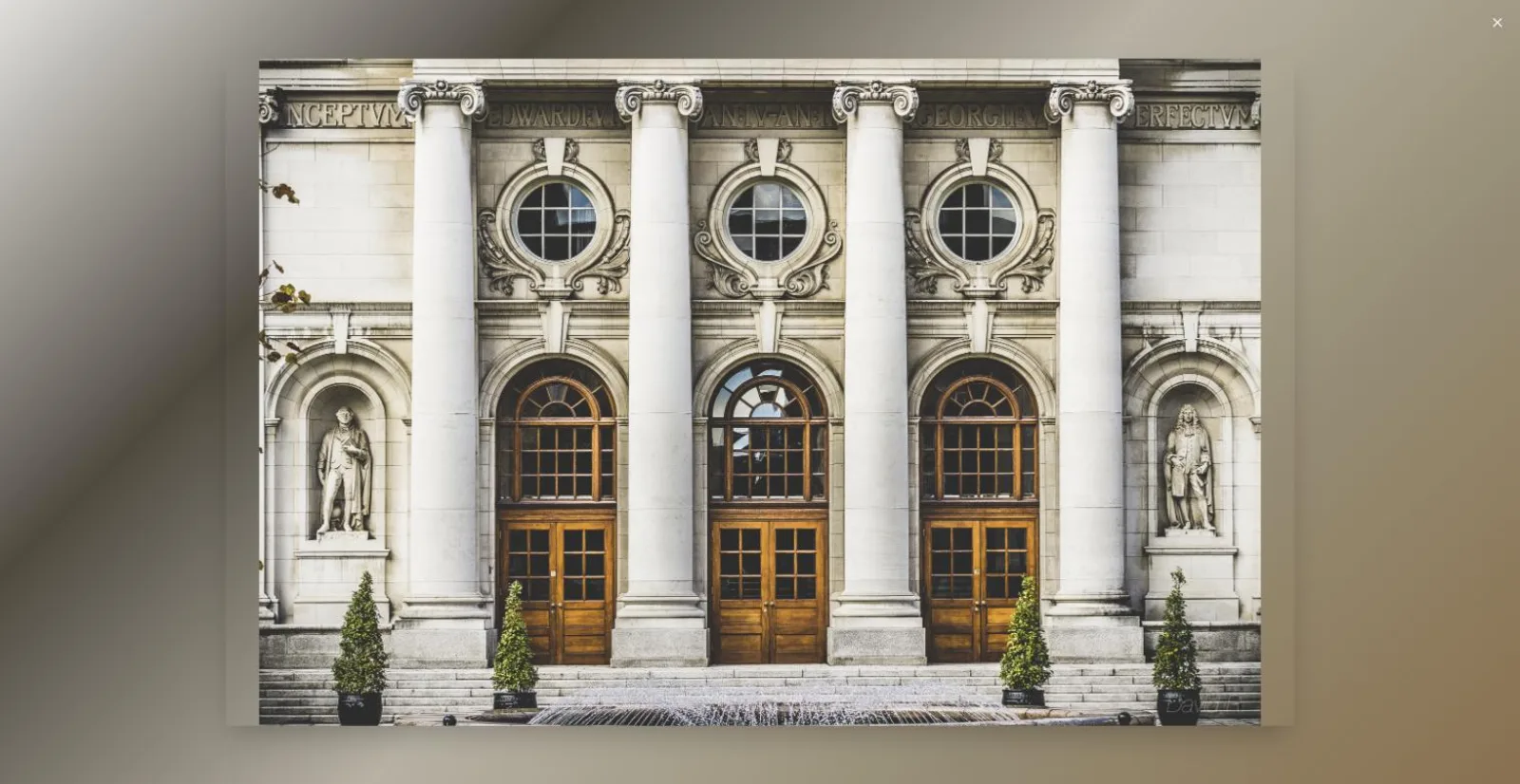 The same photograph open in a fullscreen lightbox, backdrop tinted from the image's own dominant colors